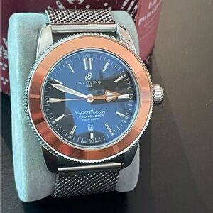 Breitling Blue and Silver Watch with Round Face and Mesh Band